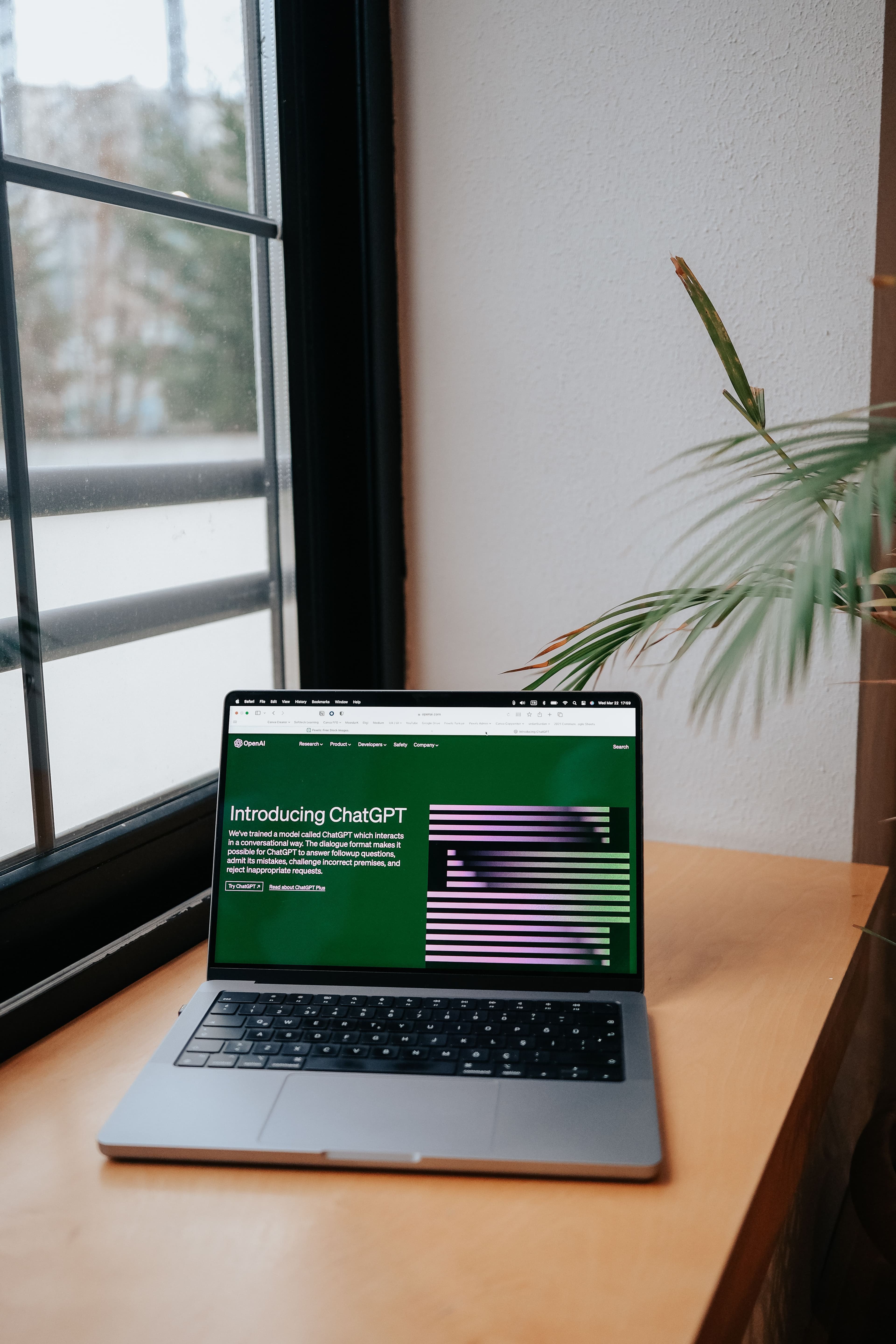 Laptop displaying the OpenAI “Introducing ChatGPT” webpage on screen.